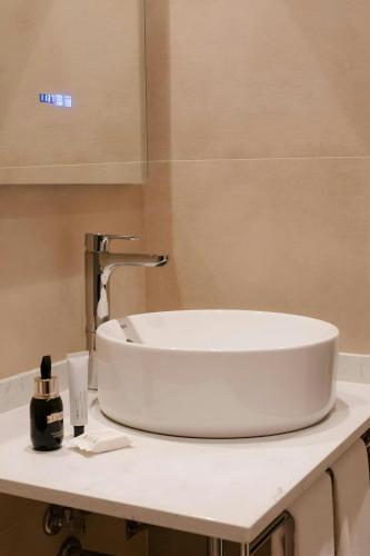 a white sink on a counter in a bathroom at Los Arcos Hotel Gothic Quarter, Sonder by Marriott Bonvoy in Barcelona