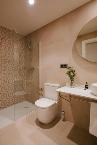 a bathroom with a toilet and a shower and a sink at Los Arcos Hotel Gothic Quarter, Sonder by Marriott Bonvoy in Barcelona