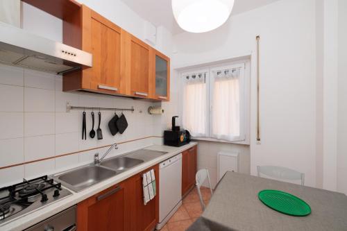 a kitchen with a sink and a counter top at Ostia Bella Apartment in Lido di Ostia