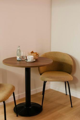 a table with two chairs and a bowl of food on it at Los Arcos Hotel Gothic Quarter, Sonder by Marriott Bonvoy in Barcelona