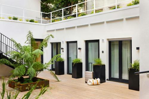 a courtyard of a building with potted plants at Yvette Hotel Porte de Versailles, Sonder by Marriott Bonvoy in Vanves