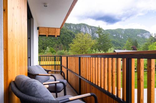 a balcony with two chairs and a view of a mountain at Vila Nina Bohinj in Bohinj