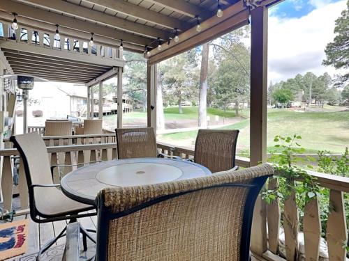 a patio with a table and chairs on a porch at Innsbrook 254 in Ruidoso