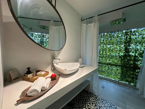 a bathroom with a sink and a mirror on a counter at Leclerc Hotel Boutique Cali Granada in Cali