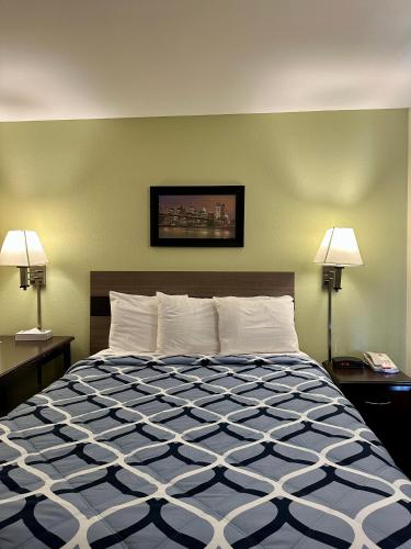 a bedroom with a large bed with two lamps at Sea Girt Lodge in Sea Girt