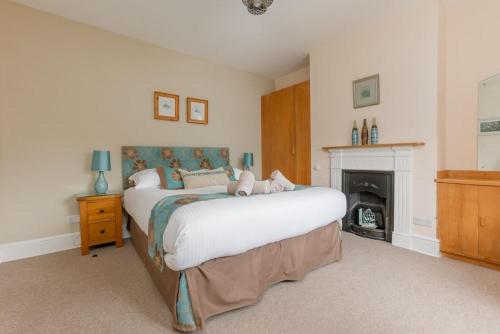 a bedroom with a bed with a teddy bear on it at Capstone in Swanage