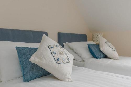 a white bed with pillows on top of it at Capstone in Swanage