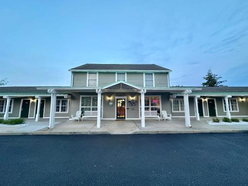 a large house with a porch with white columns at Sea Girt Lodge in Sea Girt