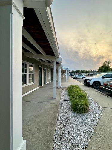 a building with white columns and cars parked in a parking lot at Sea Girt Lodge in Sea Girt