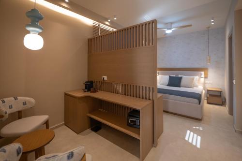a small bedroom with a bed and a desk at Parga Harbor Suites in Parga