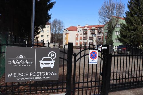 a sign on a fence in front of a house at Hotel Nihil Novi in Radom
