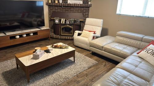 a living room with a couch and a coffee table at Spacious 4-Bdr Retreat in Charming Ste-Rose, Laval in Laval