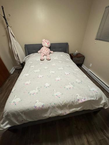 a teddy bear sitting on top of a bed at Spacious 4-Bdr Retreat in Charming Ste-Rose, Laval in Laval