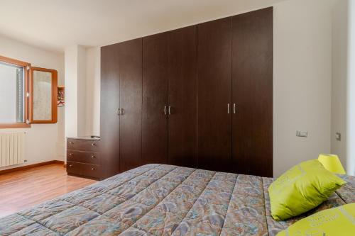 a bedroom with a bed and wooden cabinets at Casa Nonna Tetta - Salento Selection in Taurisano