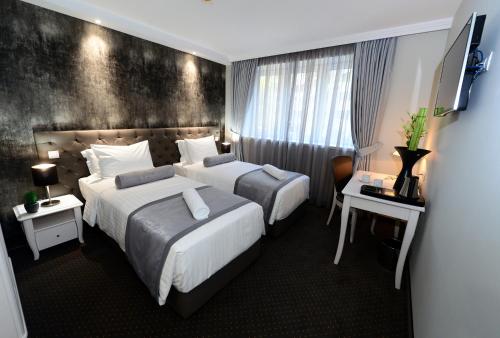 Postel nebo postele na pokoji v ubytování Alexandar Square Boutique Hotel