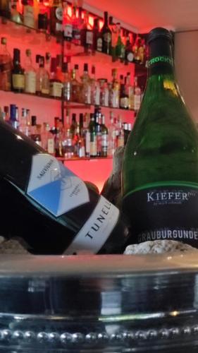 a bottle of wine sitting on top of a table at Villahotel Rheinblick in Cologne