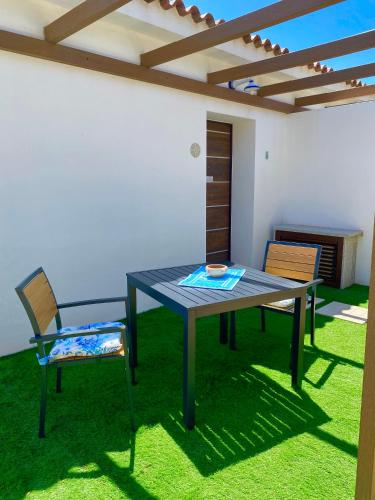 a table and chairs in a patio with a pergola at Tenute Efis in Galtellì