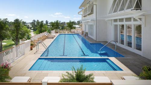 a swimming pool in the middle of a building at Naples Beach Club, A Four Seasons Resort in Naples