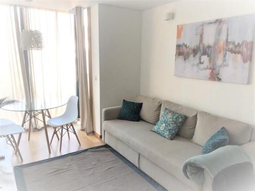 a living room with a couch and a table at Oporto Yellow Apartments in Porto
