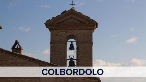 a building with a bell tower with the words colombia at Casetta in collina 1 in Colbordolo