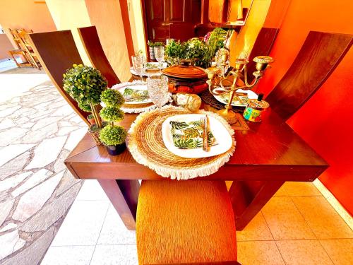 a wooden table with plates of food on it at TRAVELLERS BEAUTIFUL ELEN Agios Gordios Sea in Agios Gordios
