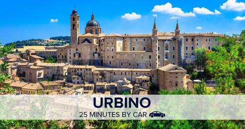 a large building with a city in front of it at Casetta in collina 1 in Colbordolo