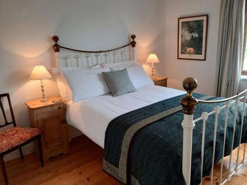 a bedroom with a large white bed and two lamps at Moynish Mor Mulranny in Westport