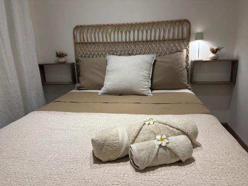 a bedroom with a bed with two towels on it at Le Christina in Saint-Paul
