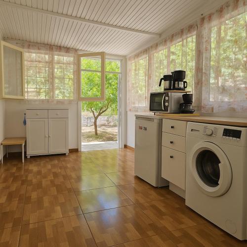 a kitchen with a washing machine in a room at Annoula's place in Chios