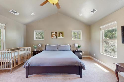 a bedroom with a large bed and two windows at Sweet Vista in Groveland