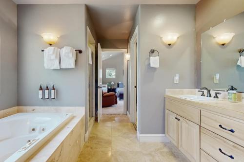 a bathroom with a large tub and a sink at Sweet Vista in Groveland