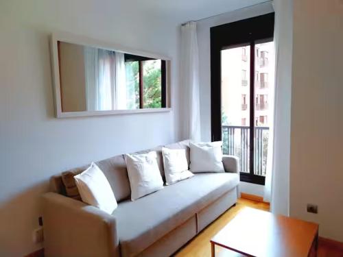 a living room with a couch and a mirror at Areropuerto Wanda en Plenilunio 3 3 B in Madrid
