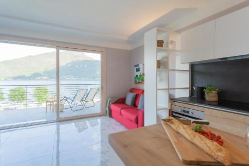 a kitchen and living room with a view of the ocean at Misultin House & Swimming pool, Luxury in Lake Como by Rent All Como in Pianello Del Lario