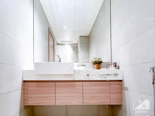 a bathroom with a sink and a mirror at Luxury Living in Azizi Riviera l Cozy Balcony in Dubai