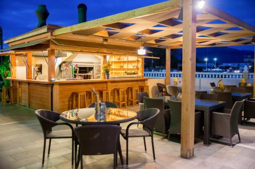 a restaurant with tables and chairs and a patio area at Hotel Noguera El Albir in Albir