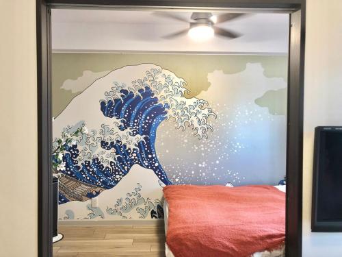 a wall with a painting of a wave at New Built Apartment Hokusai-kan Osaka Nishinari in Osaka