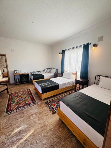 a bedroom with two beds and a couch at Soleado Cappadocia Hotel in Uchisar