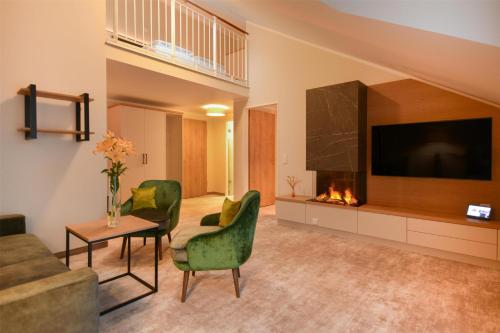 a living room with a couch and a fireplace at Dorint Strandresort & Spa Ostseebad Wustrow in Wustrow