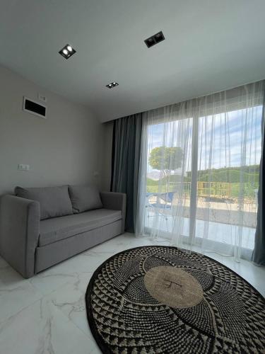 a living room with a couch and a large window at Jasmine Resort & Aqua park in Sharm El Sheikh