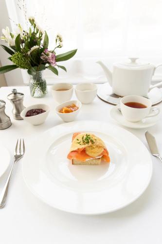 a white table with a plate of food on it at Knockinaam Lodge in Portpatrick