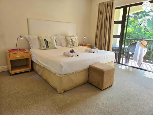 a bedroom with a bed with two stuffed animals on it at Villa T7 - Selborne Golf Estate in Pennington
