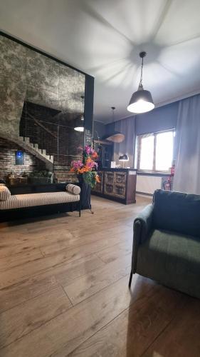 a living room with a couch and a fireplace at Apartamenty Na Skarpie in Płock