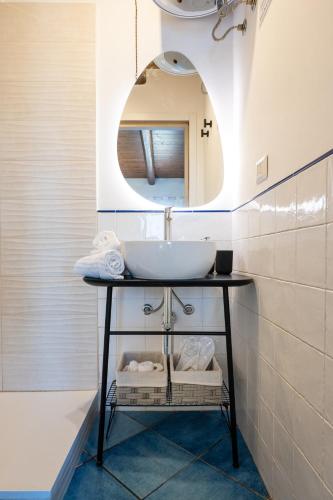 a bathroom with a sink and a mirror at CefalHome - TORRE in Cefalù