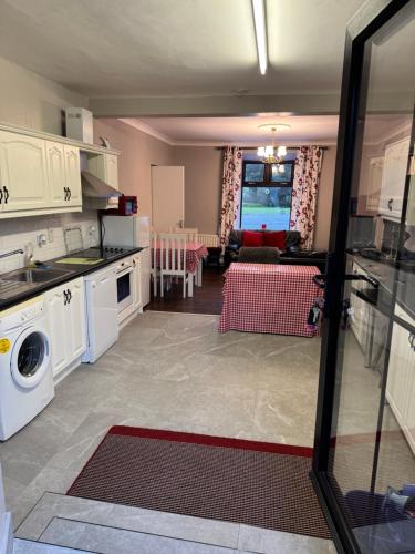 a kitchen and living room with a washer and dryer at Reelin Bar Holiday Accommodation in Cloghan