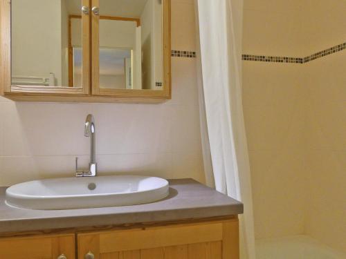 une salle de bain avec un lavabo et un miroir dans l'établissement Studio 3* pour 4 pers. avec balcon, skis aux pieds, proche commerces et remontées mécaniques - FR-1-182-193, à Les Allues