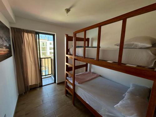 Ένα ή περισσότερα κρεβάτια σε δωμάτιο στο Lindo Departamento con Terraza Vista al Mar