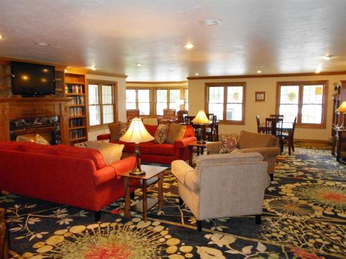 a living room with red couches and chairs at Pheasant Park Resort in Sister Bay
