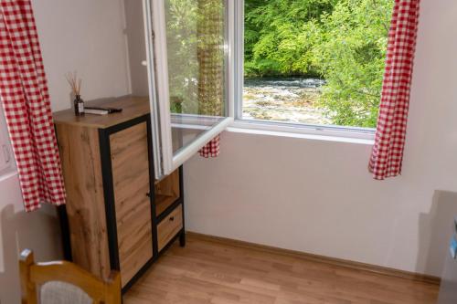 a window in a room with a table and a wooden floor at Domacinstvo na kraju svijeta in Šipovo