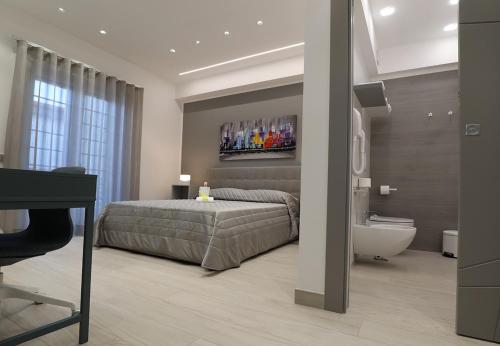 a bedroom with a bed and a tub and a sink at Borgo Alto B&B in Boscotrecase