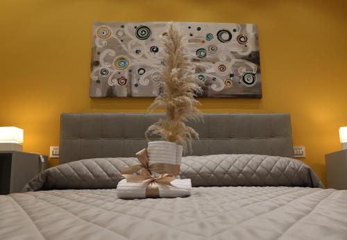 a bedroom with a bed with a painting on the wall at Borgo Alto B&B in Boscotrecase